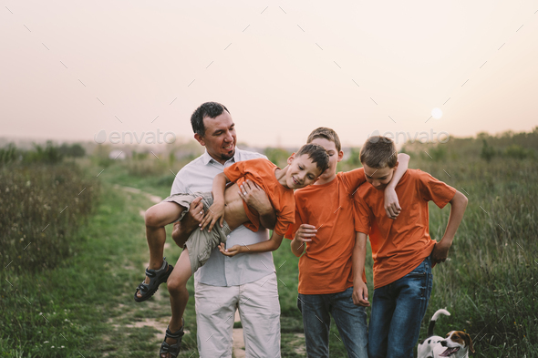 Happy Fathers day. Father with son are walking in the field. - Stock Photo - Images