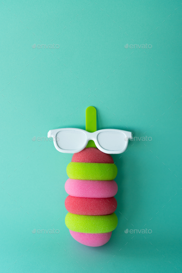 Colored popsicle with glasses on mint background. Minimal summer concept. - Stock Photo - Images