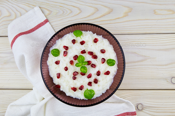 Curd rice in a bowl. A popular dish from South India with rice, yogurt, spices, pomegranate.