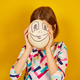 Playful teenager girl covering her face of Ostrich egg with funny face - PhotoDune Item for Sale