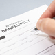 Hand filling a Bankruptcy form - PhotoDune Item for Sale