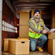 Mid adult courier among packages in back of delivery truck looking at camera - PhotoDune Item for Sale