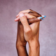Close-up of Afro woman&#39;s hand with blue nails intertwined with Caucasian man&#39;s hands. - PhotoDune Item for Sale
