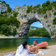 couple on vacation in the Ardeche France Pont d Arc, view of Narural arch Pont D&#39;arc Canyon France - PhotoDune Item for Sale
