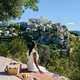 Couple on vacation in Southern france looking out over the old historical village of Gordes Luberon - PhotoDune Item for Sale