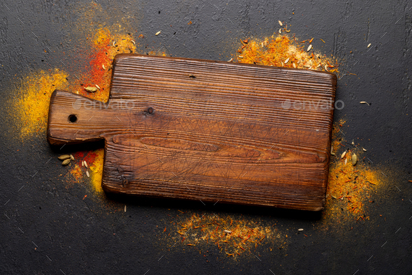 Empty cutting board over various spices