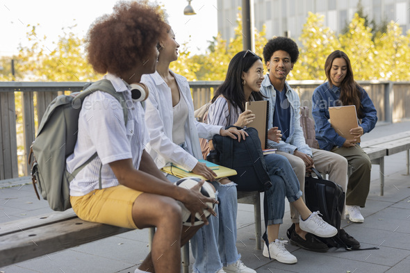 group of multiracial classmates meeting on campus at break - exchange students -