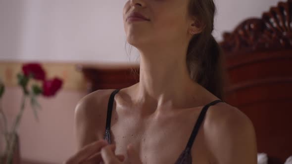 Slim Woman with Closed Eyes Meditating in Bedroom at Home Smiling alt