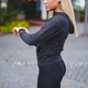 Young blonde woman checking her fitness smart watch device in city - PhotoDune Item for Sale
