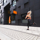 Sporty young woman running fast in minimalist urban environment - PhotoDune Item for Sale