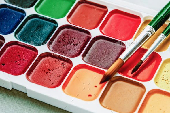 Closeup Of Watercolor Paintbox And Paint Brush Stock Photo