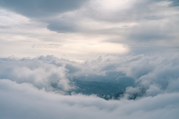 Flowing clouds in winter mountain at sunset - Stock Photo - Images