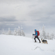 Man hiking with dog in beautiful winter mountain - PhotoDune Item for Sale
