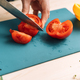 Woman cutting tomato for vegetable salad with microgreens - PhotoDune Item for Sale