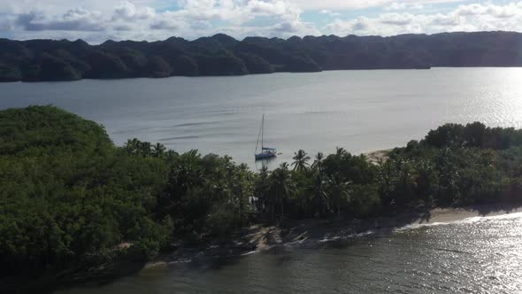 4k 24fps Droni In The Caribbean Beach With Mountains Behind And The Sailboat In The Water alt