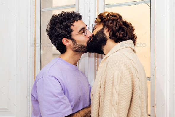 happy couple of gay men kissing at home - Stock Photo - Images