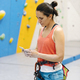 Rock climber woman looking at smartphone. - PhotoDune Item for Sale