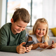 Little kids holding smartphone, tablet playing mobile game online, child and gadget concept - PhotoDune Item for Sale
