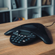 speakerphone on wooden table at office with blurred bookshelves on background - PhotoDune Item for Sale