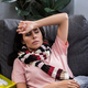 sick young woman with scarf lying on couch at home - PhotoDune Item for Sale