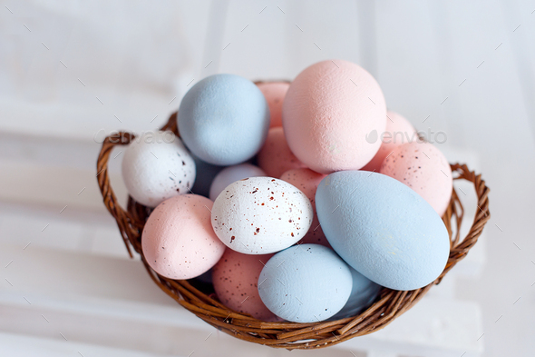 Easter eggs in the woven basket isolated on white background . Pastel color Easter eggs - Stock Photo - Images