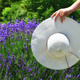 Female holding a white sun hat in a field of lavender.  - PhotoDune Item for Sale
