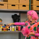 Dressmaker with pink hair and colorfull clothes choosing a thread. - PhotoDune Item for Sale