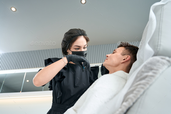 Man in bathrobe getting face anti age injection - Stock Photo - Images