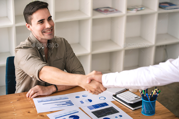 young businessman shake hands and agree to do business together - Stock Photo - Images