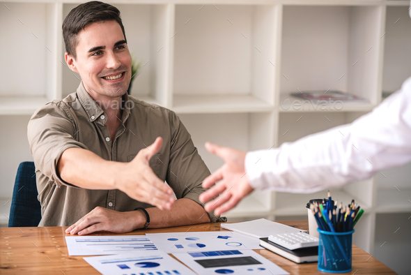 young businessman shake hands and agree to do business together - Stock Photo - Images