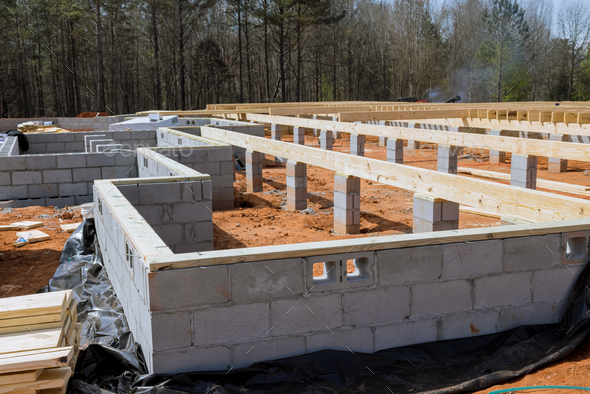 Cement blocks laid a wall for foundation of house on construction site. - Stock Photo - Images