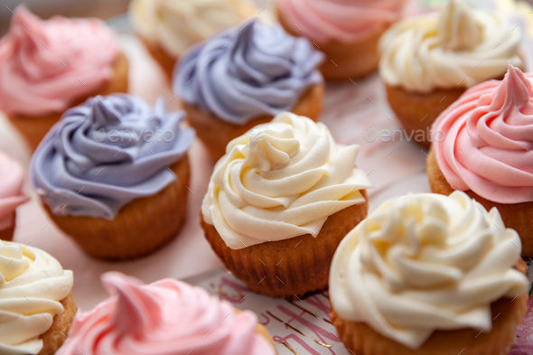 Colorful Birthday cupcakes freshly made collected on the table in a selective focus - Stock Photo - Images