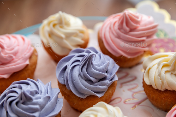 Top view of colorful cupcakes freshly made for Birthday party in a selective focus - Stock Photo - Images
