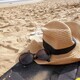Sitting on a mat at the beach on a sunny day with my hat and sunglass for sun protection. - PhotoDune Item for Sale