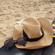 Sitting on a mat at the beach on a sunny day with my hat and sunglasses for sun protection. - PhotoDune Item for Sale