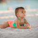 Infant baby girl relaxing on sandy beach at summer vacation - PhotoDune Item for Sale
