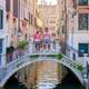 couple men and women on a city trip in Venice Italy sitting above a bridge at the canals of Venice - PhotoDune Item for Sale