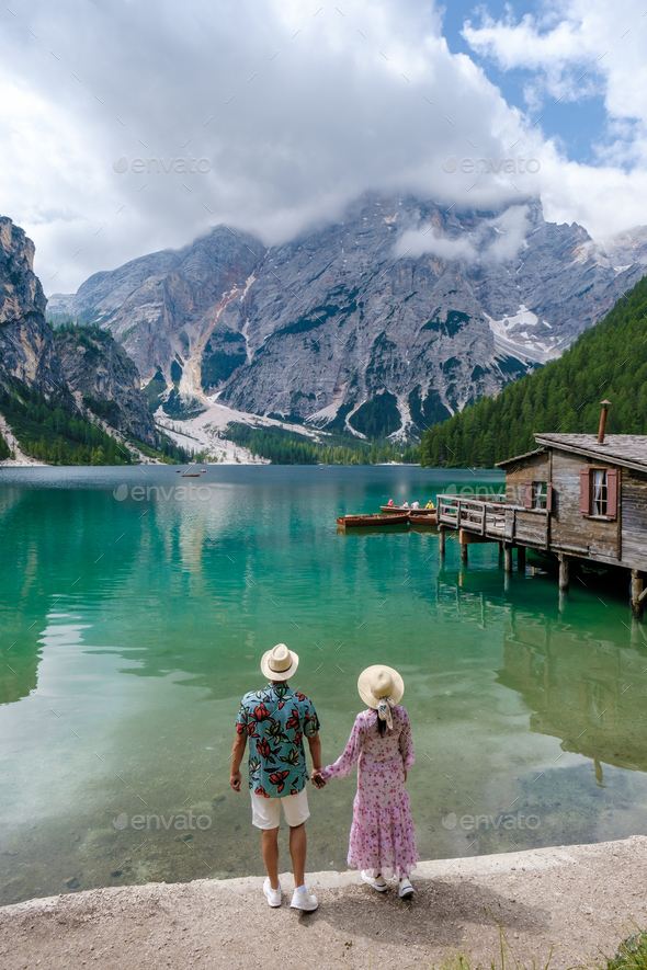 couple visit Braies Lake Lago di Braies Italian Dolomites alpine lake Italy, Europe - Stock Photo - Images