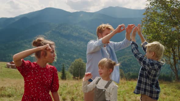 Parents Giving Five Children on Meadow alt