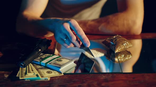 Drugs addict preparing cocaine lines. Cocaine powder sorted. Concept of drugs abuse. Social problems alt