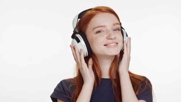 Young Beautiful Caucasian Foxy Teenage Girl Listening Music Through Headphones Dancing Smiling on alt