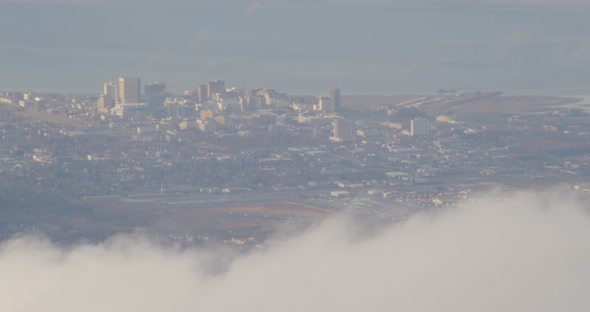 Aerial shot past snowy Alaskan mountaintops at dusk, drone helicopter footage alt