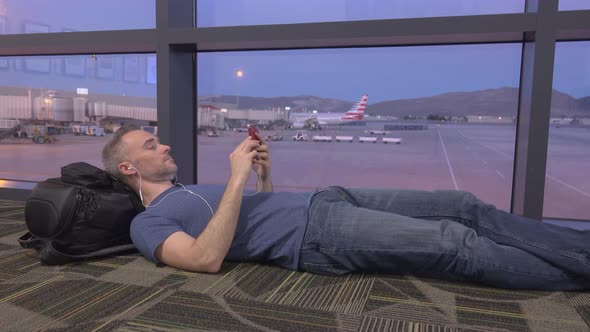 Man Resting on Floor After Fight Cancellation alt
