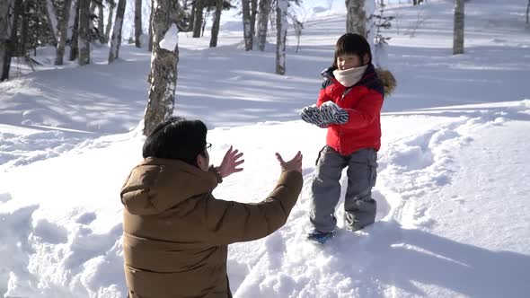 Asian Father And Son Playing In The Park On Winter Day  alt