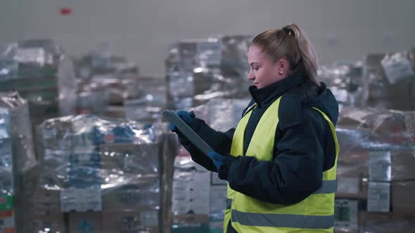 Girl Makes Notes in the Warehouse