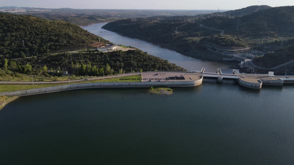 ON A CLEAR DAY YOU CAN SEE FOREVER written on Alqueva dam. Aerial forward descendent alt