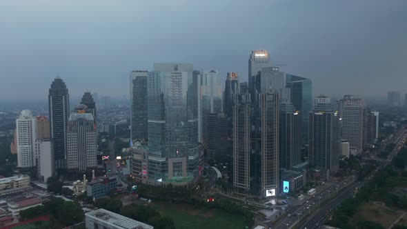Aerial Truck View Circling Around a Building Complex of Multiple Skyscrapers in Modern City Center alt