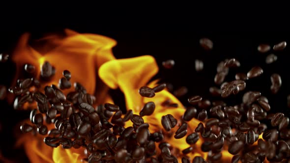 Super Slow Motion Shot of Flames and Coffee Beans Explosion on Black Background at 1000Fps alt