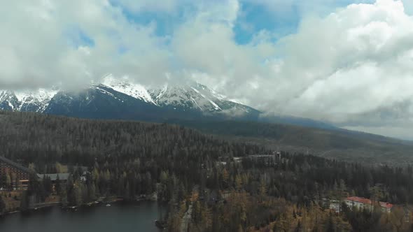 Aerial View of Strbske Pleso in the Clouds and Snowy Mountains. Slovakia alt