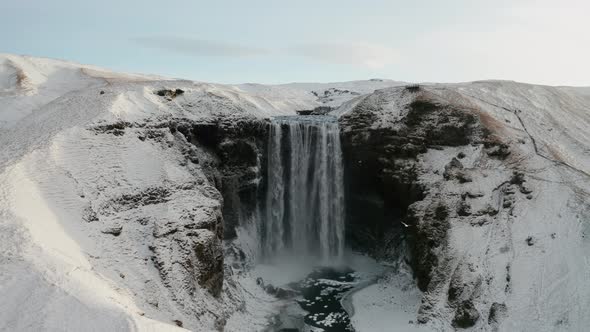 Aerial View of Skogafoss Waterfall During Sunrise. Iceland in Early Spring